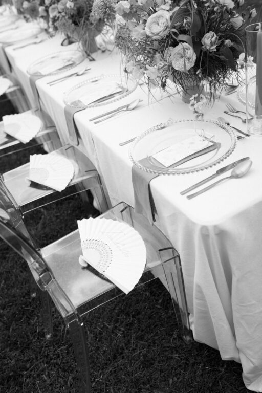 Fächer liegt auf transparenten Stuhl bei exklusiven Hochzeitstablesetting fotografiert von Hochzeitsfotografin Laura Kaiser