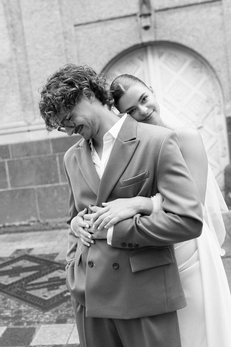 braut umarmt braeutigam von hinten 1